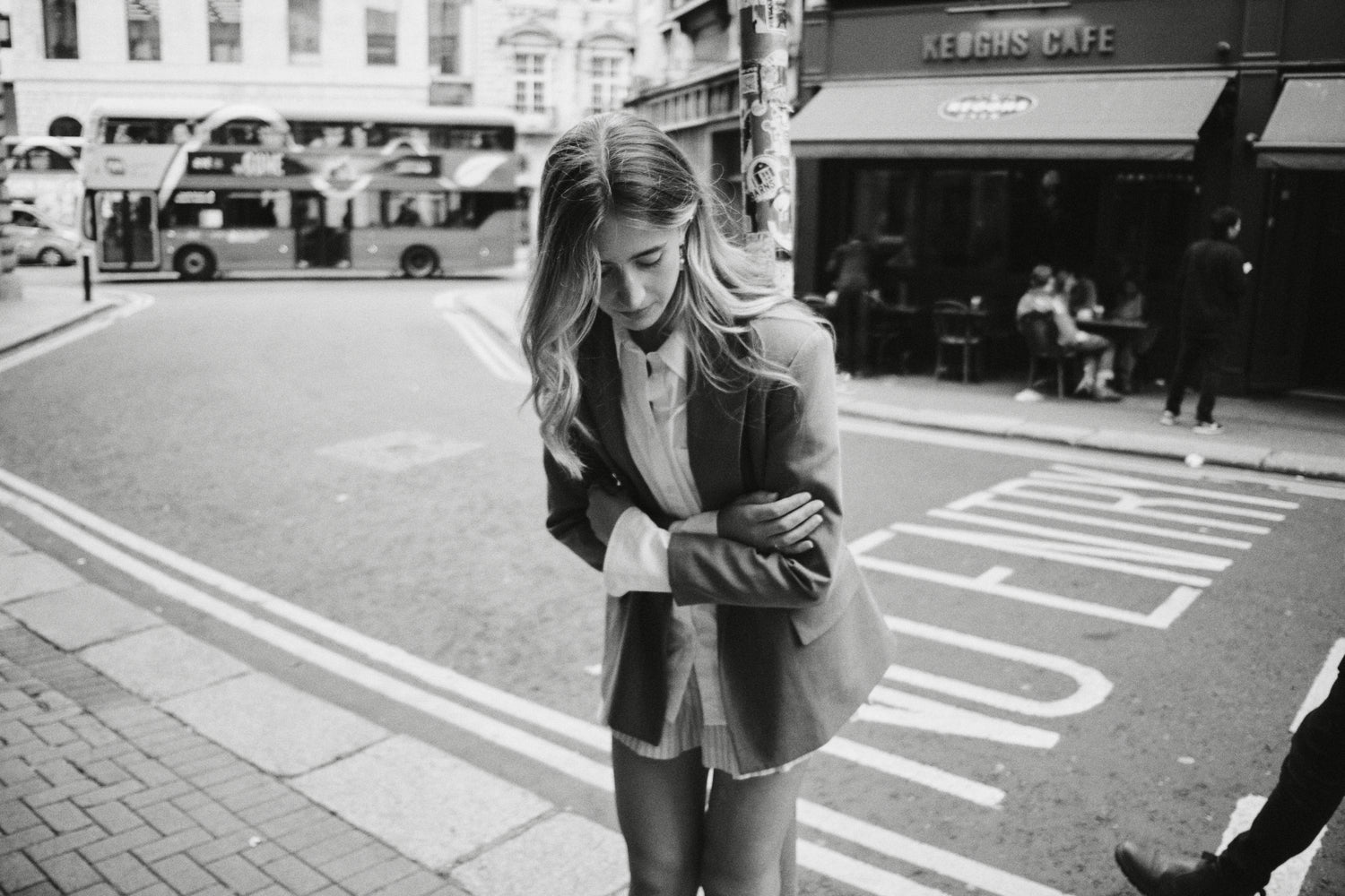 Woman standing on a city street with a blurred background